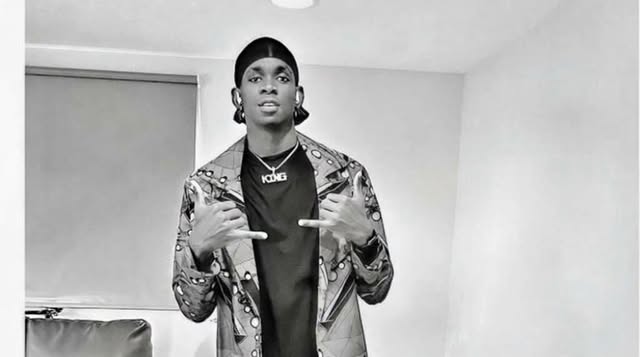 Black and white photo of SECKY in a patterned jacket
