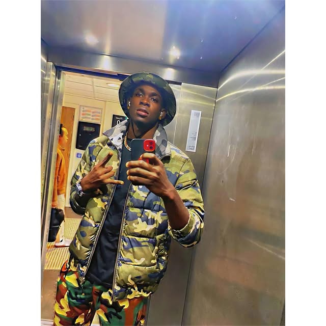 SECKY in a camouflage puffer jacket and bucket hat in a lift